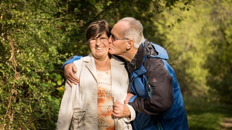 man and wife kissing cheek