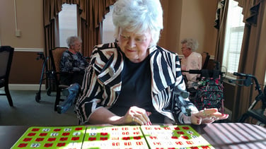 Image of elderly woman playing bingo