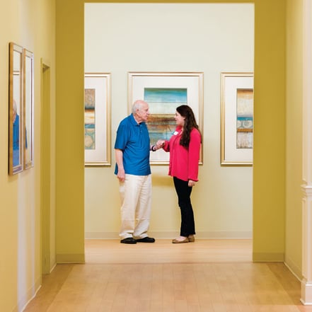 Photo of a man and a woman standing in hallway