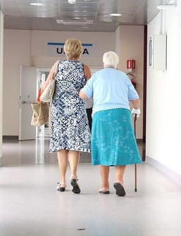assisted living conversation tactics senior mother and daughter walking in hospital