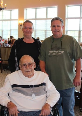 Family visiting their dad in the dining room of his assisted living community