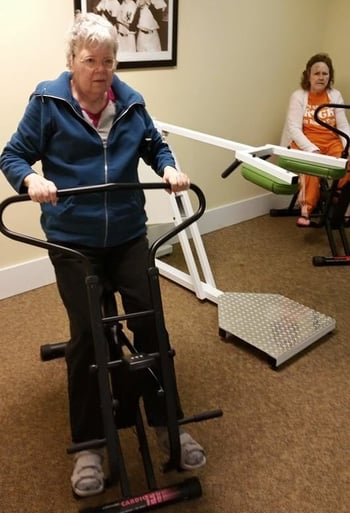 Women using exercise equipment at their senior living community