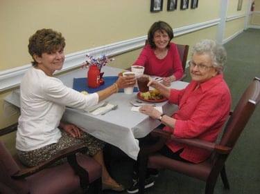 Senior women celebrate together at resident social