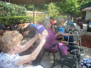 Assisted living community doing social strength exercises