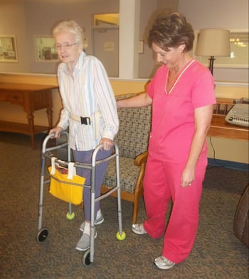 Nursing home resident doing assisted exercises