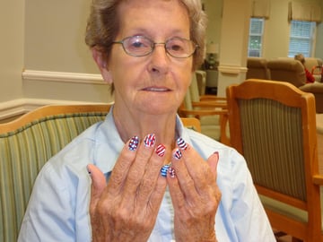 Senior resident being pampered at nail salon in assisted living community