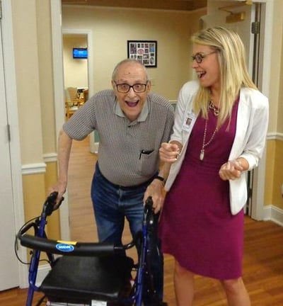 Staff member and resident at a Senior Solutions Management Group Assisted Living Community