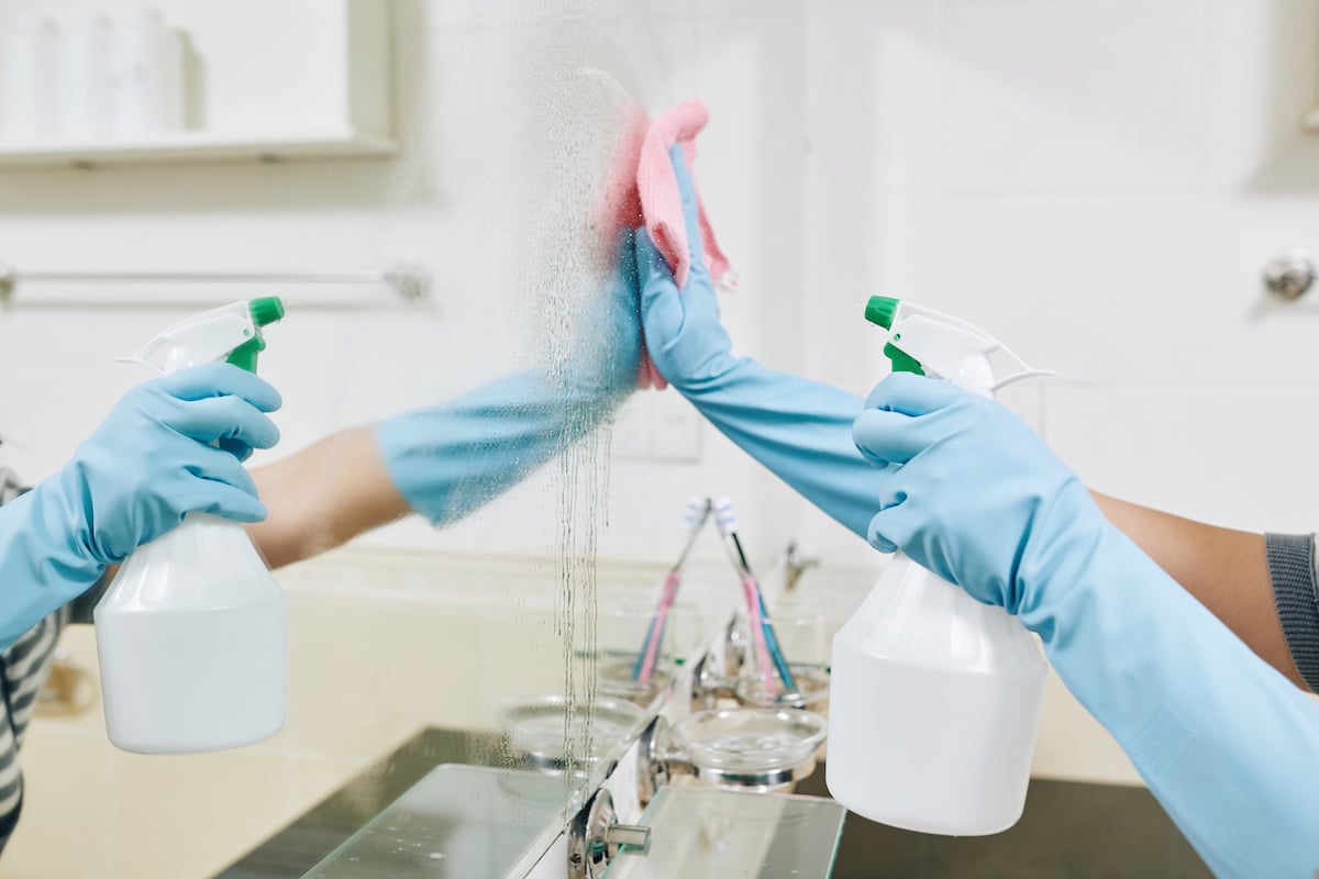 Woman cleaning mirror